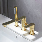 A modern three-hole bathroom faucet set with a polished gold finish, featuring a central spout and two separate handles, mounted on a white sink against a gray tiled wall.