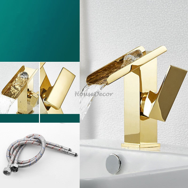 Gold bathroom basin mixer tap waterfall spout detail view