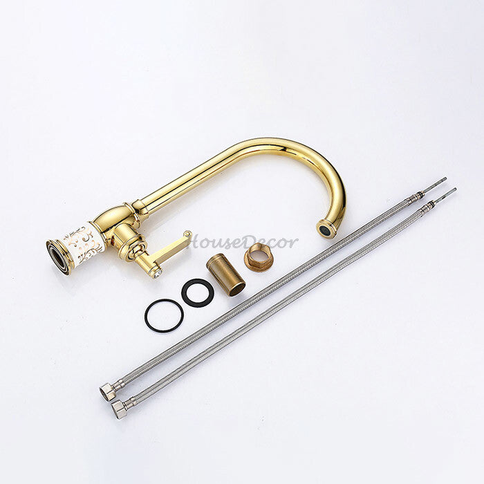Gold kitchen sink mixer tap swivel spout detail view