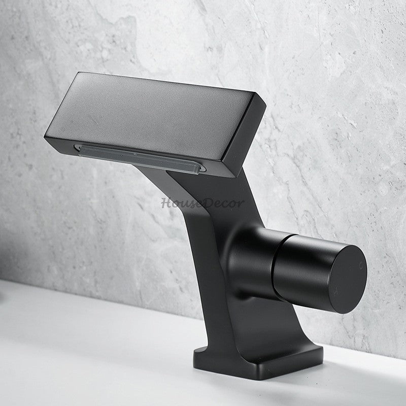 Brass bathroom basin mixer tap waterfall spout detail view