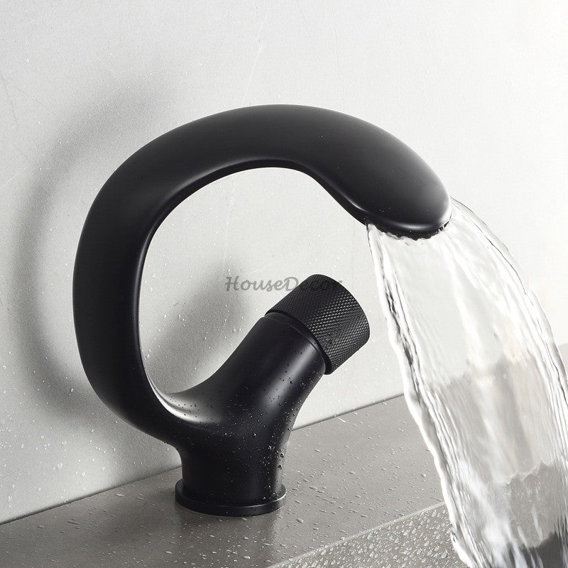 Modern bathroom basin mixer tap waterfall spout detail view