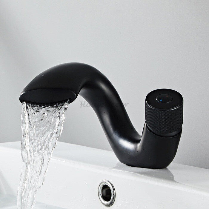 Brass bathroom basin mixer tap waterfall spout detail view