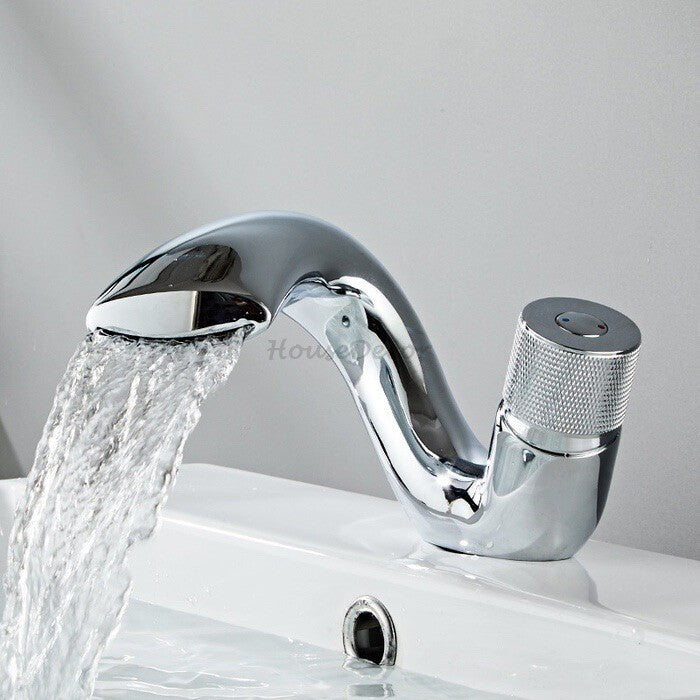 Brass bathroom basin mixer tap waterfall spout detail view